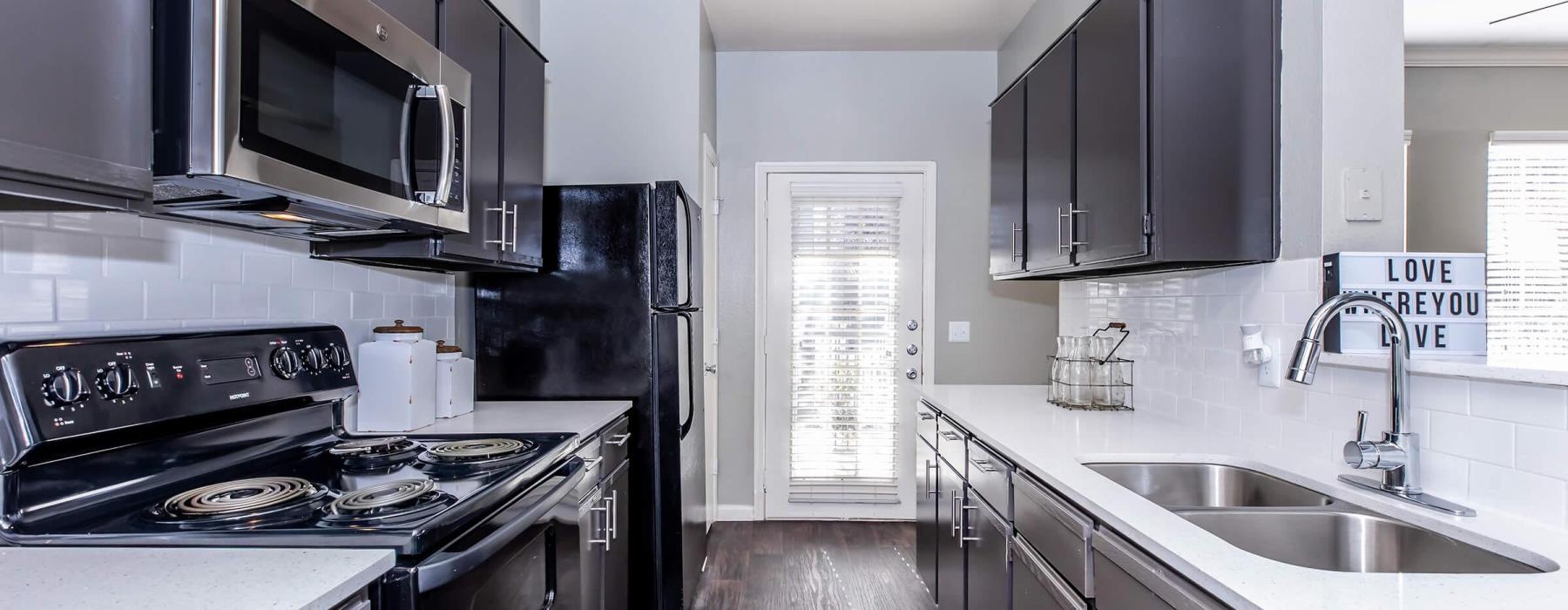 a kitchen with black appliances
