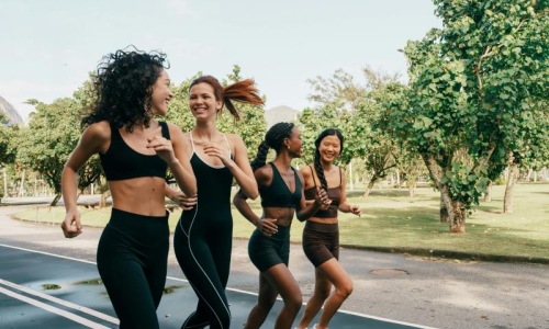a group of women running on a road