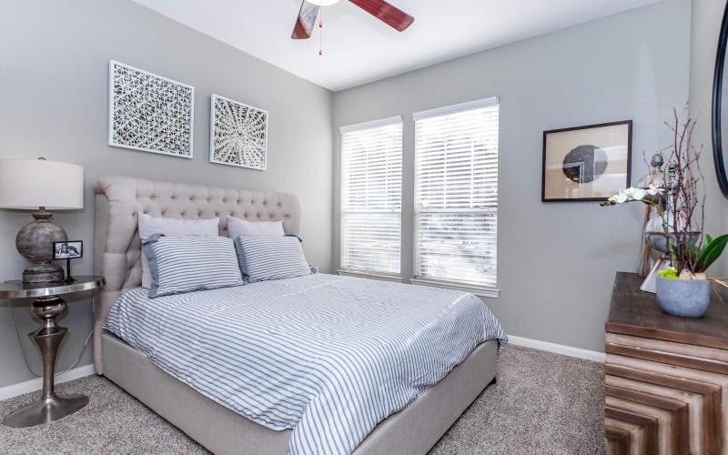 a bedroom with a bed and a lamp